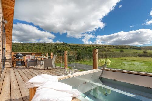 a hot tub on the deck of a house at Little Heaning in Cartmel