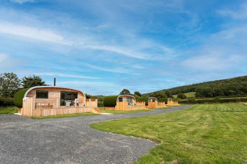 a row of wooden huts on a gravel road at Little Heaning in Cartmel