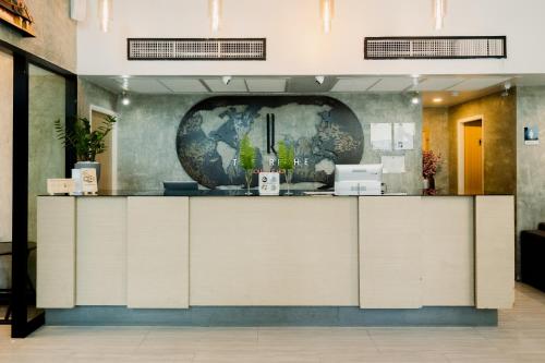 a lobby with a counter in a building at The Riche Boutique Hotel Don Mueang Airport in Bangkok