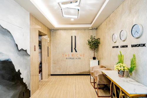 a lobby of a hotel with a sign that reads the ridge at The Riche Boutique Hotel Don Mueang Airport in Bangkok