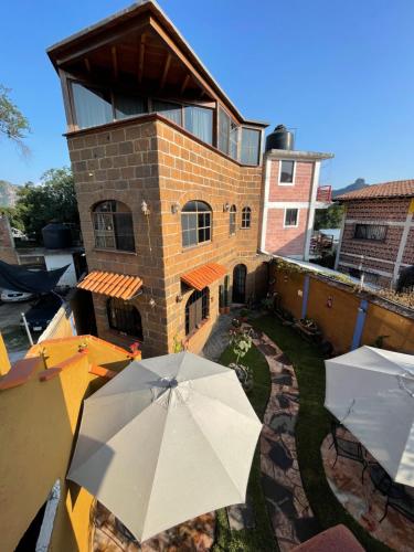 a building with an umbrella in front of it at Ma Petite Maison in Tepoztlán