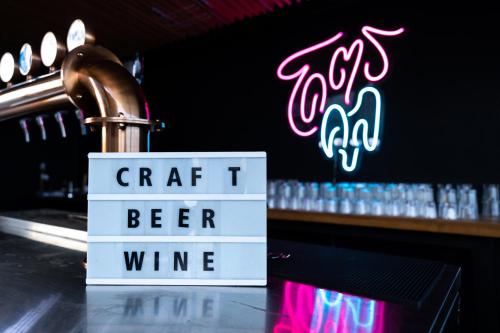 a sign that says craft t beer wine on a bar at The Riche Boutique Hotel Don Mueang Airport in Bangkok