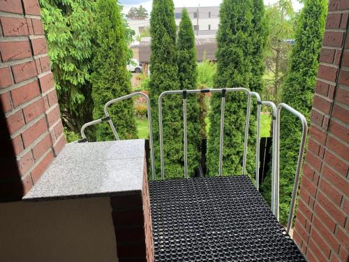 a metal gate with a bench on a balcony at Apartmány City 2 in Ostrava