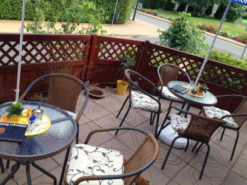 a group of tables and chairs on a patio at Pension & Café Meine Sonne Sole Mio in Bad Sooden-Allendorf