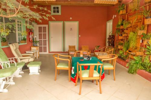 a dining room with a table and chairs in a room at Pousada Irashai in Juquei