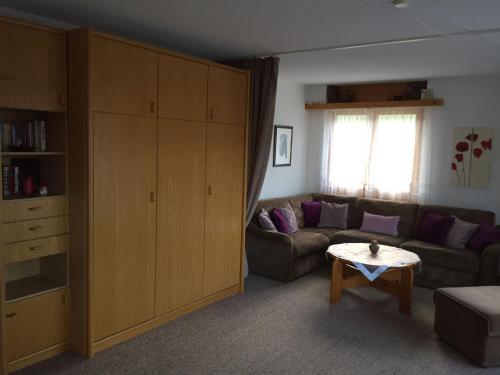 a living room with a couch and a table at Ferienwohnung im Haus Primula in Obersaxen