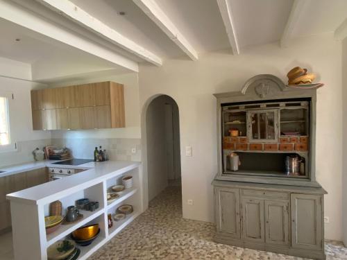 a kitchen with a counter and a cabinet in a room at Lovely "Provence" villa with sea view, private heated pool, airco and beautiful garden in Grimaud