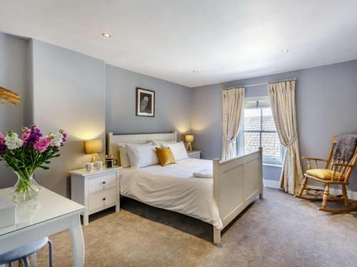 a bedroom with a bed and a desk and a window at Beechfield in Harrogate