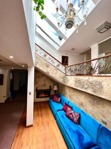 a blue couch in a living room with a ceiling at Dakani Hotel Boutique NEW in Quito