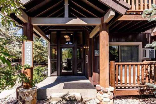 a front door of a home with a wooden roof at Mountain Getaway - Pool, Hot Tub, Balcony, WiFi in Park City