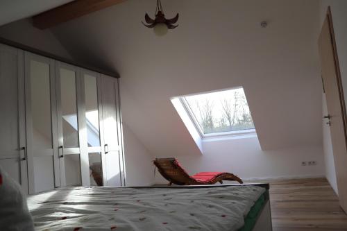 a bedroom with a bed and a window at Naturferienhof Märkisch Luch - a64537 