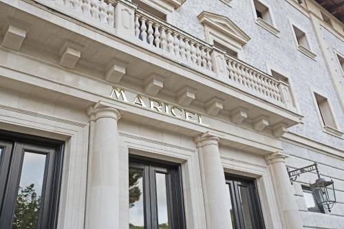 a building with a sign on the side of it at Hospes Maricel y Spa, Palma de Mallorca, a Member of Design Hotels in Cas Catala