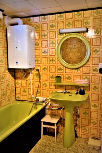a bathroom with a sink and a bath tub at Maison Jeanny, full house with big garden in Frasnes-lez-Anvaing