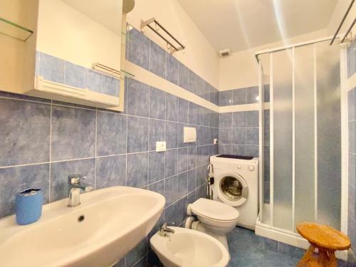 a bathroom with a sink toilet and a washing machine at CasaViva - Cozy Trilo in Camogli with AC in Camogli