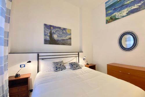 a bedroom with a large white bed with two pillows at CasaViva - Cozy Trilo in Camogli with AC in Camogli