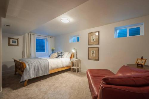 a bedroom with a bed and a couch at Modern Apartment close to freeway! in Salt Lake City