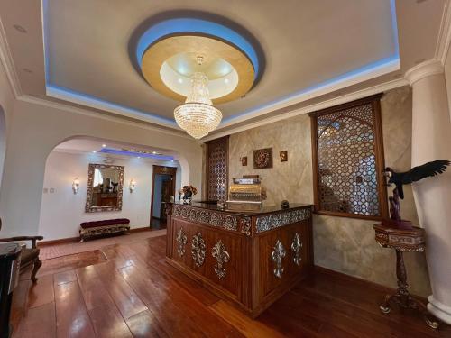 a living room with a ceiling with a chandelier at Dakani Hotel Boutique NEW in Quito