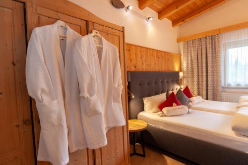 a bedroom with two beds and towels hanging up at Apart Harmonie in Kappl