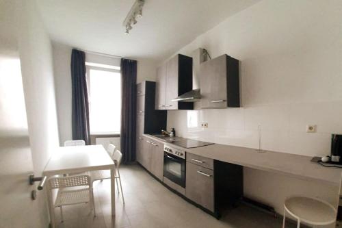 a kitchen with a counter and a table and chairs at Apartament with terrace in Mitte Berlin 2011 in Berlin