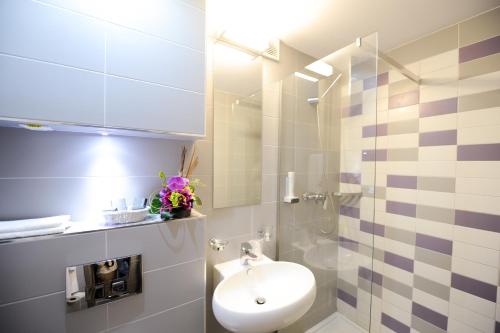 維納斯的住宿－旋律酒店，浴室配有卫生间、盥洗盆和淋浴。