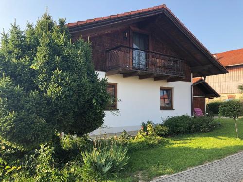 a house with a balcony on top of it at Seehäuschen - Waging Tettenhausen in Waging am See