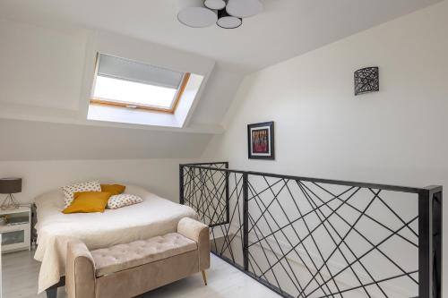 1 dormitorio con 1 cama con silla y ventana en Maison Mareuil, en Mareuil-lès-Meaux