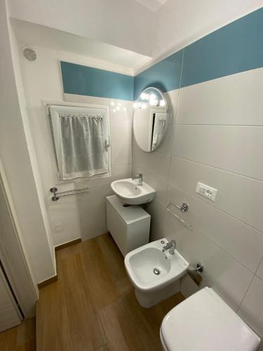 a bathroom with a white toilet and a sink at Dimora Garibaldi Apartment & Room in Agrigento