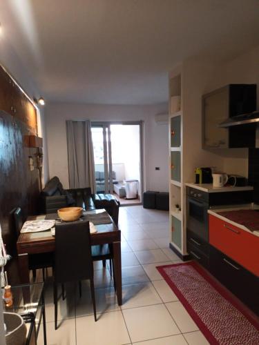 a kitchen and living room with a table and a dining room at La torre in Latina