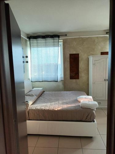 a bedroom with a bed and a window at La torre in Latina
