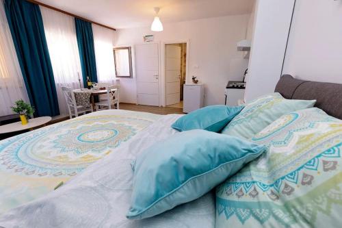 a bedroom with a bed with blue pillows on it at Holiday Spa House Kostanjevec in Velika Gorica