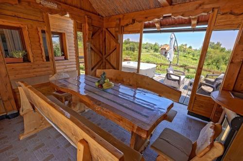 a wooden dining room with a large wooden table at Kuća za odmor Kostanjevec in Donja Lomnica