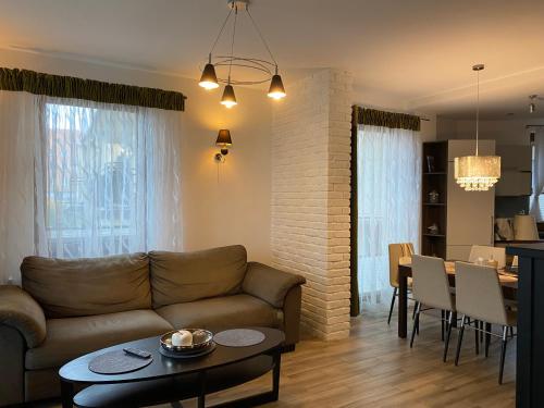 a living room with a couch and a table at Inalda in Ełk