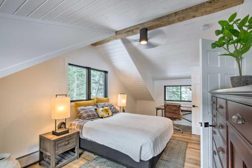 a bedroom with a bed and two lamps on a table at Modern Riverfront Home 6 Mi to Big Sky Town! in Gallatin Gateway