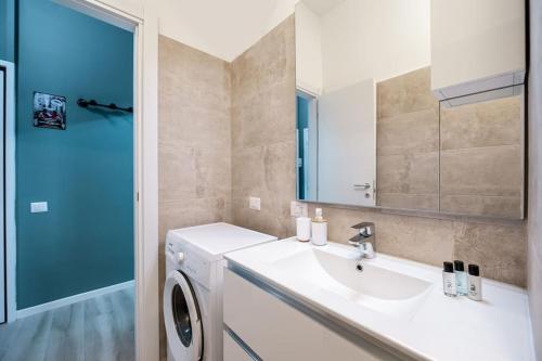 a bathroom with a sink and a washing machine at [Linate Airport] Elegant Suite,Tram 1 minute away in Milan
