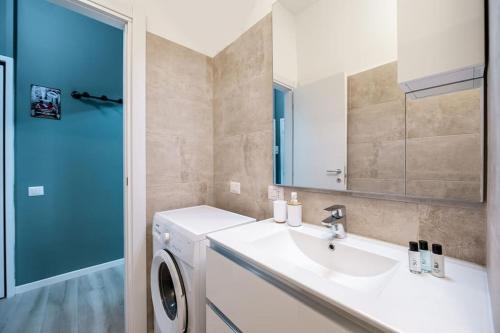 a bathroom with a sink and a washing machine at [Linate Airport] Elegant Suite,Tram 1 minute away in Milan