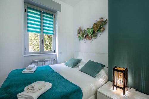 a bedroom with a large bed with towels on it at [Linate Airport] Elegant Suite,Tram 1 minute away in Milan