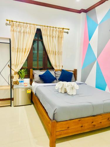 a bedroom with a bed with towels on it at Lanta Grand House in Ko Lanta