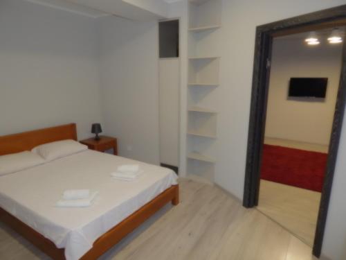 a bedroom with a bed and a mirror at Confortable apartment in Chişinău