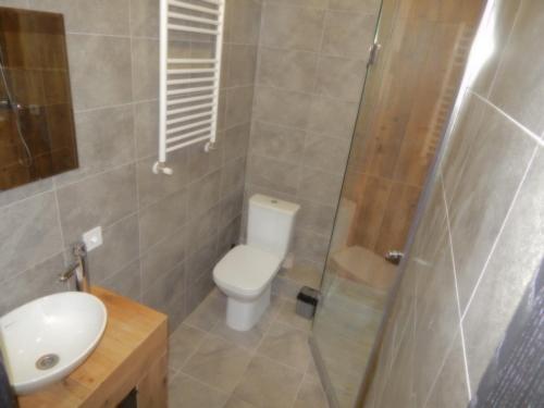 a bathroom with a toilet and a sink and a shower at Confortable apartment in Chişinău