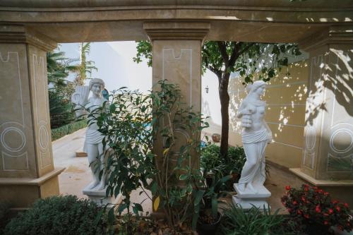 two statues of women in a garden at Andalusian Palace in Priego de Córdoba