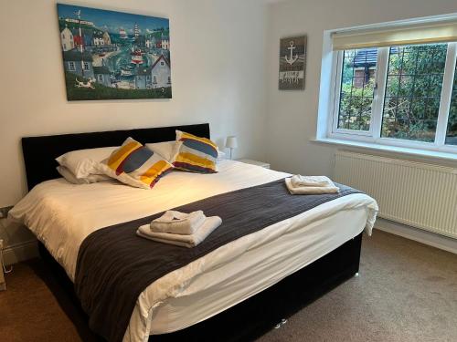 a bedroom with a large bed with towels on it at Castlebar in Great Singleton