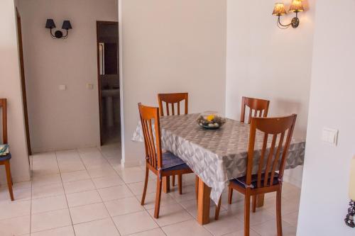 a dining room with a table and chairs at Amazing and Cosy Apt near the Beach ByCentralgarve in Quarteira