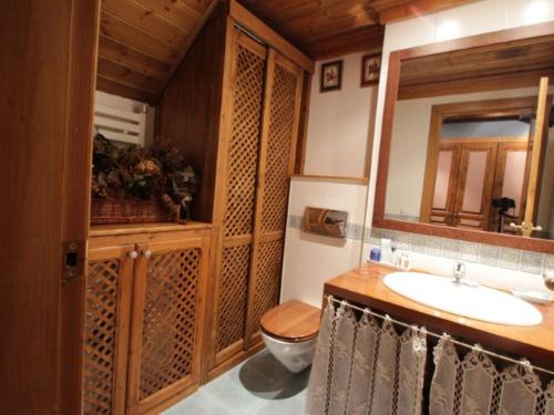 a bathroom with a sink and a toilet and a mirror at Baqueira Pleta de Neu in Naut Aran