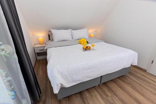 a small bedroom with a bed with flowers on it at Kuća za odmor Holiday Spa House Kostanjevec s bazenom,saunom i jacuzzijem,Zagreb in Velika Gorica