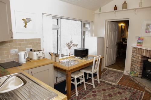 a kitchen with a table and a counter top at Dromard Guest Accommodation in Enniskillen