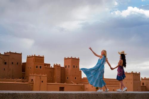two girls walking in front of a castle at Berbère Palace in Ouarzazate