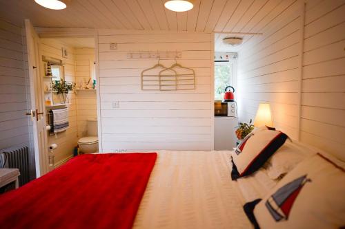 a bedroom with a large bed with a red blanket at Seagrove Beach Cabin in Seaview