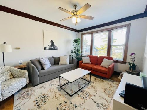 a living room with two couches and a ceiling fan at The Karlov. Gorgeous ,spacious 2BD/ 1BA w/ Parking in Chicago