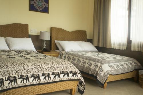 a bedroom with two beds and a window at Dharma Beach in Montañita