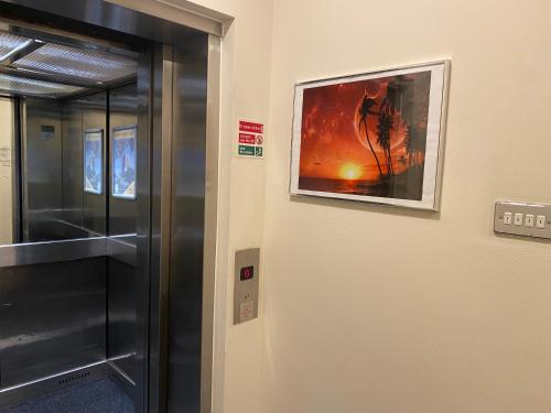 a elevator in a room with a painting on the wall at Grand Plaza Serviced Apartments in London